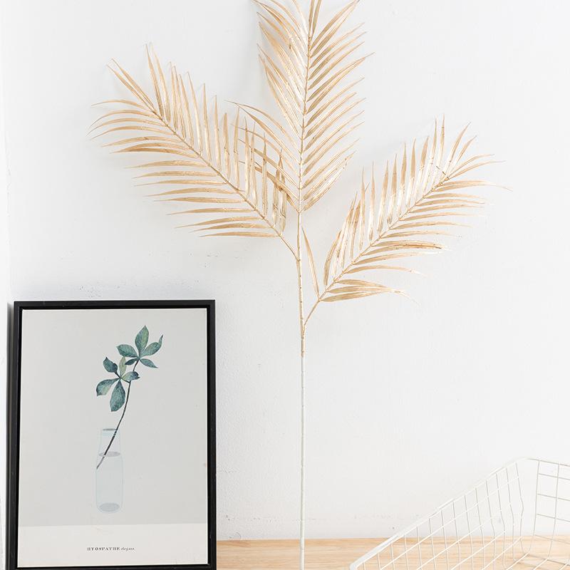 Trang trí đám cưới giả màu vàng: lá eucalyptus, hoa giả, cành giả, chi tiết vàng cho trang trí lối đi.